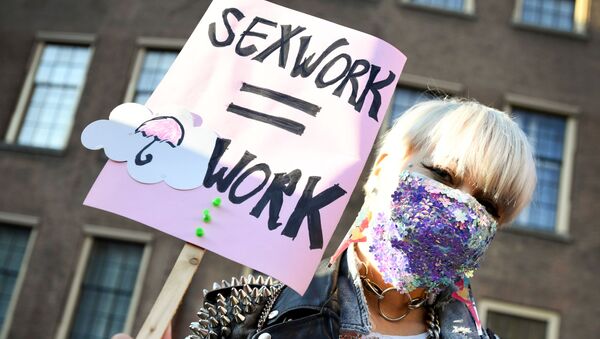 A protester holds a placard as Dutch sex workers demonstrate to demand the right to go back to work, amid the coronavirus disease (COVID-19) pandemic, in The Hague, Netherlands March 2, 2021 - Sputnik International