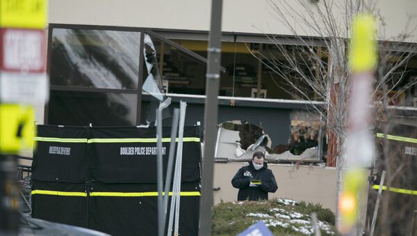 Police work on the scene outside of a King Soopers grocery store where authorities say multiple people were killed in a shooting, Monday, March 22, 2021, in Boulder, Colorado.  - Sputnik International