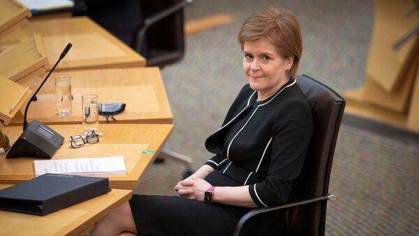 Scotland's First Minister Nicola Sturgeon sits at the main chamber ahead of a coronavirus disease (COVID-19) briefing at the Scottish Parliament in Holyrood, Edinburgh, Scotland, Britain March 23, 2021. - Sputnik International
