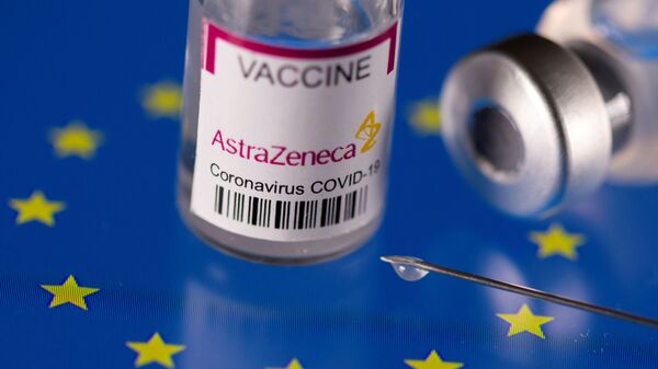 FILE PHOTO: Vials labelled AstraZeneca coronavirus disease (COVID-19) vaccine placed on displayed EU flag are seen in this illustration picture - Sputnik International