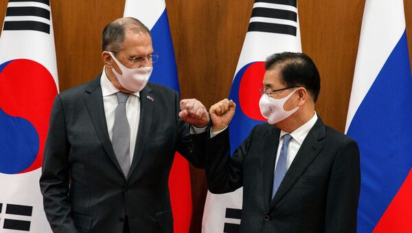 Russian Foreign Minister Sergei Lavrov (L) bumps elbows with his South Korean counterpart Chung Eui-yong before their meeting at the foreign ministry in Seoul, South Korea, March 25, 2021 - Sputnik International