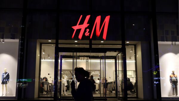 A woman walks past a store of the Swedish fashion retailer H&M at a shopping mall in Beijing, China March 24, 2021 - Sputnik International