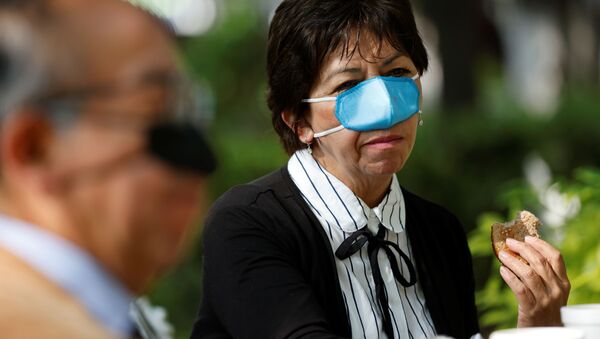 Ana Maria Gonzalez wears a new innovation, a nasal mask designed by Mexican scientist Gustavo Acosta Altamirano, as a measure to protect against the coronavirus disease (COVID-19) transmission during the process of eating and drinking at the National Polytechnic Institute, in Mexico City, Mexico March 18, 2021 - Sputnik International