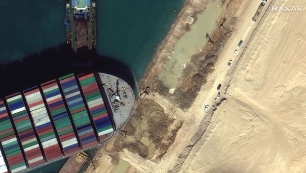 A view of the earth moving equipment excavating sand near the bow of the Ever Given container ship, in Suez Canal in this Maxar Technologies satellite image taken on March 27, 2021 - Sputnik International