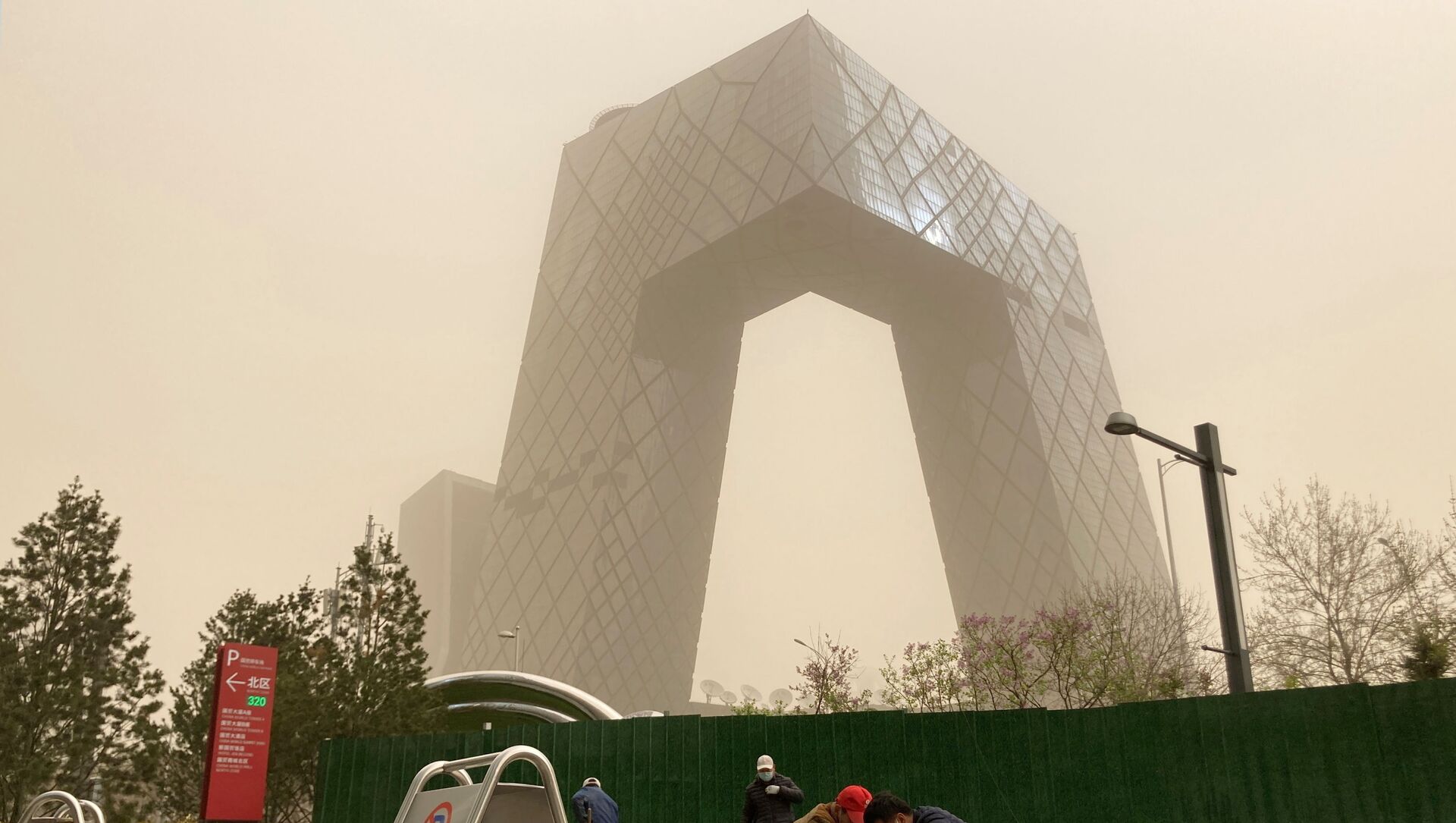 Construction workers are seen in front of the CCTV headquarters shrouded in dust as the city is hit by a sandstorm, in Beijing, China March 28, 2021. - Sputnik International, 1920, 28.03.2021