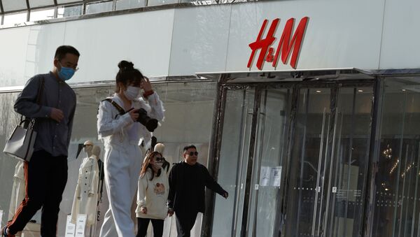 People walk past an H&M store in a shopping area in Beijing, China, 28 March 2021 - Sputnik International