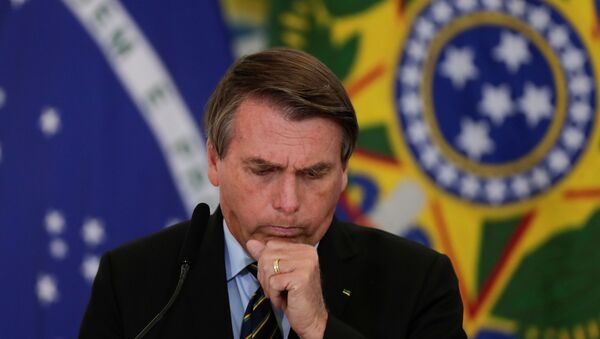 Brazil's President Jair Bolsonaro coughs during a ceremony to announce measures by Caixa Economica bank in support of philanthropic hospitals, in Brasilia, Brazil March 25, 2021. - Sputnik International