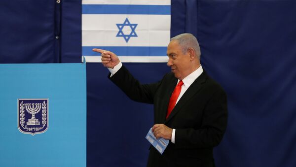 FILE PHOTO: Israeli Prime Minister Benjamin Netanyahu gestures while standing near a voting booth as he prepares to cast his ballot in Israel's general election, at a polling station in Jerusalem, 23 March 2021.  - Sputnik International
