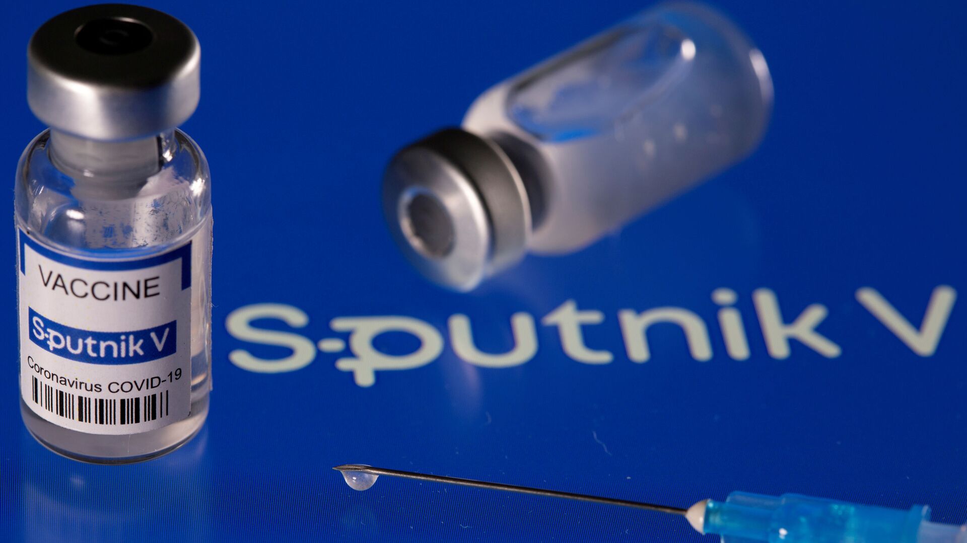 Vial labelled Sputnik V coronavirus disease (COVID-19) vaccine placed on displayed Sputnik V logo is seen in this illustration picture taken March 24, 2021. - Sputnik International, 1920, 15.09.2021