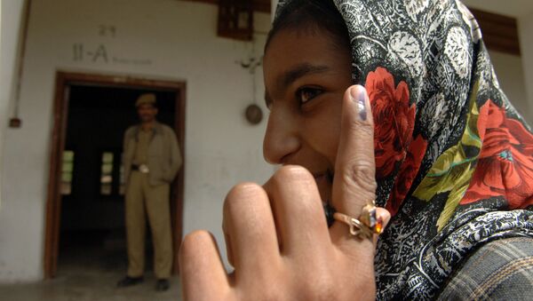 A first time voter showing the ink mark on her finger after casting her vote at a polling booth of Budgam, Srinagar in Jammu & Kashmir during the 4th Phase of General Election-2009 in New Delhi on May 7, 2009 - Sputnik International