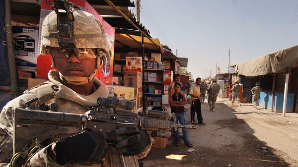 U.S. Army Staff Sgt. Jerrime Bishop provides security during a joint dismounted presence patrol with Iraqi National Police at a market in Narhwan, Iraq, Nov. 1, 2007. - Sputnik International