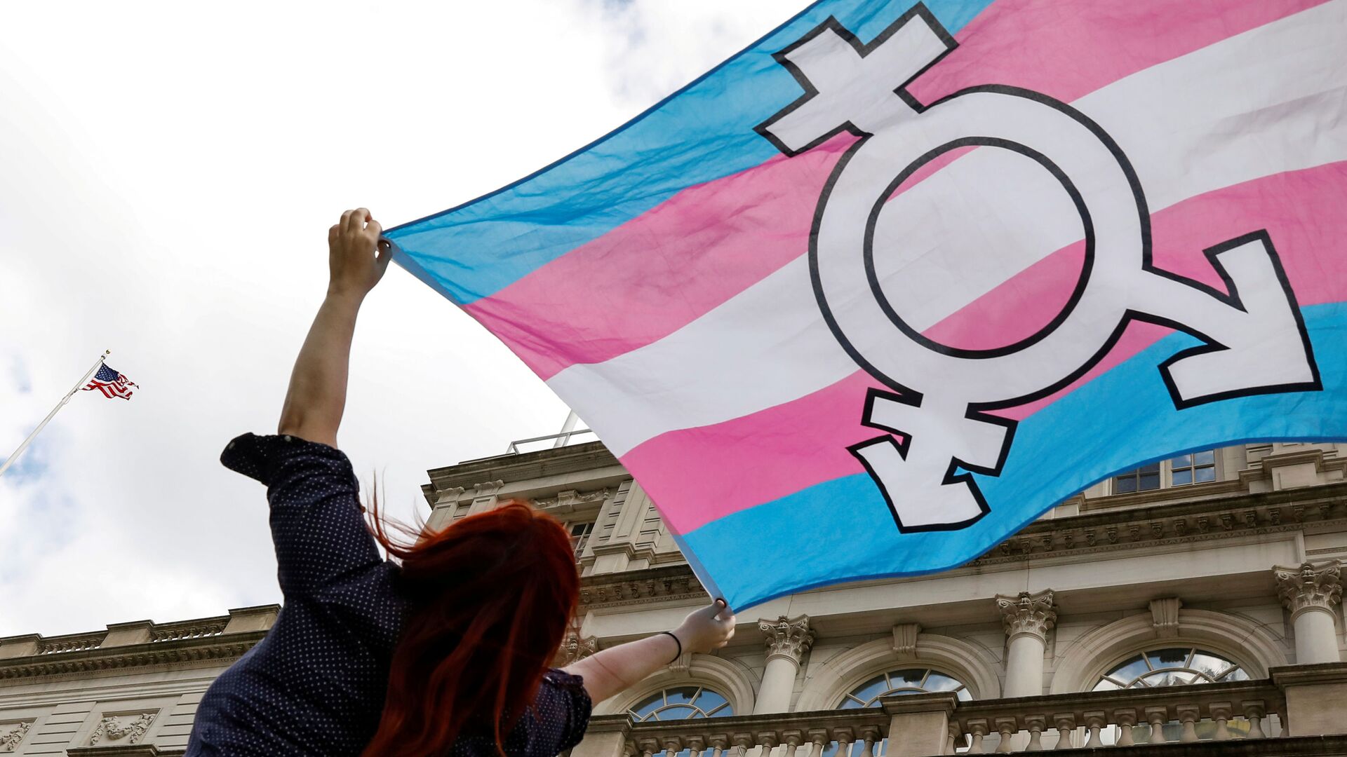 FILE PHOTO: A person holds up a flag during rally to protest the Trump administration's reported transgender proposal to narrow the definition of gender to male or female at birth, at City Hall in New York City, U.S., October 24, 2018. - Sputnik International, 1920, 02.02.2022