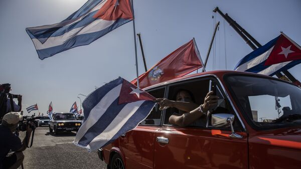 Soviet-era Lada cars flying Cuban flag drive past the American embassy during a rally calling for the end of the US blockade against the island nation in Havana, Cuba, Sunday, March 28, 2021 - Sputnik International