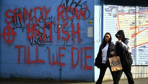 People walk past graffiti saying 'Sandy Row, British till we die' in Belfast, Northern Ireland, March 6, 2021. Picture taken March 6, 2021. REUTERS/Clodagh Kilcoyne - Sputnik International