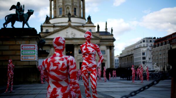 Mannequins wrapped in red and white barricade tape to symbolize the coronavirus disease crisis are placed at the Gendarmenmarkt square as part of a COVID-19 art installation It is like it is by German artist Dennis Josef Meseg in Berlin, Germany, April 3, 2021. - Sputnik International