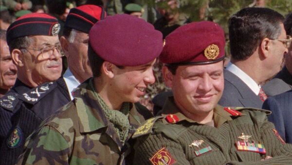 Jordan's Prince Hamza, 19, left, whispers in the ears of his elder brother, Prince Abdullah, 37, in this June 1998 photo taken during a military parade in Jordan.  - Sputnik International