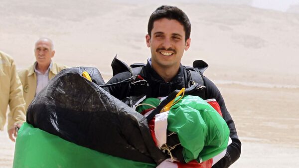 In this file photo taken on April 17, 2012 shows Jordanian Prince Hamzah bin al-Hussein, president of the Royal Aero Sports Club of Jordan, carries a parachute during a media event to announce the launch of Skydive Jordan, in the Wadi Rum desert. - A top former Jordanian royal aide was among several suspects arrested on April 3, 2021, as the army cautioned Prince Hamzah bin Hussein, the half-brother of King Abdullah II against damaging the country's security. - Sputnik International