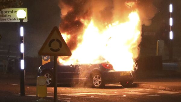 A car burns after it was hijacked by Loyalists at the Cloughfern roundabout in Newtownabbey, Belfast, Northern Ireland, Saturday, April 3, 2021. - Sputnik International