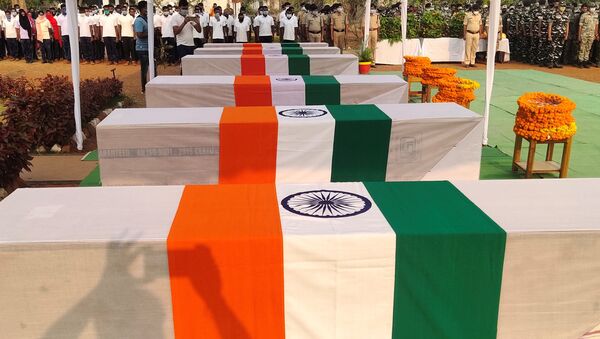 Security force personnel pay homage next to the coffins of their colleagues who were killed in an attack by Maoist fighters, during a wreath laying ceremony in Bijapur in the central state of Chhattisgarh, India, April 5, 2021 - Sputnik International