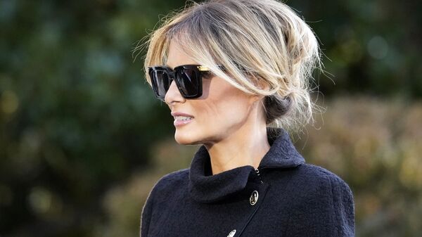 First Lady Melania Trump listens as President Donald Trump speaks with reporters as he walks to board Marine One on the South Lawn of the White House, Wednesday, Jan. 20, 2021, in Washington - Sputnik International