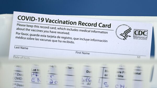A vaccination record card is shown during a COVID-19 vaccination drive for Spring Branch Independent School District education workers Tuesday, March 16, 2021, in Houston. - Sputnik International