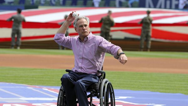 Texas Governor Greg Abbott throws out the ceremonial first pitch at the opening day baseball game between the Chicago Cubs and Texas Rangers Thursday, March 28, 2019 in Arlington, Texas.  - Sputnik International