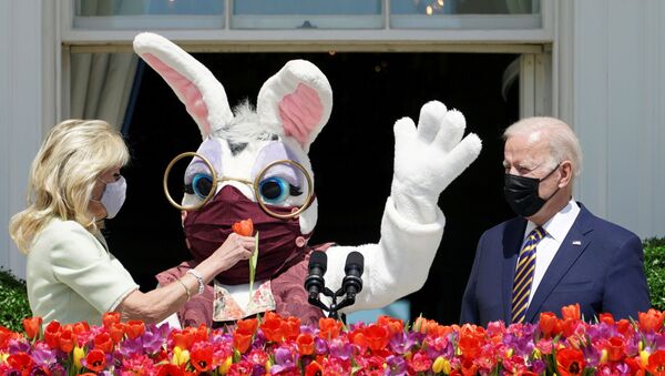 U.S. President Joe Biden stands to deliver his remarks on the tradition of Easter, next to first lady Jill Biden holding a flower and a person wearing an Easter Bunny costume  at the Blue Room Balcony of the White House in Washington, U.S. April 5, 2021.  - Sputnik International