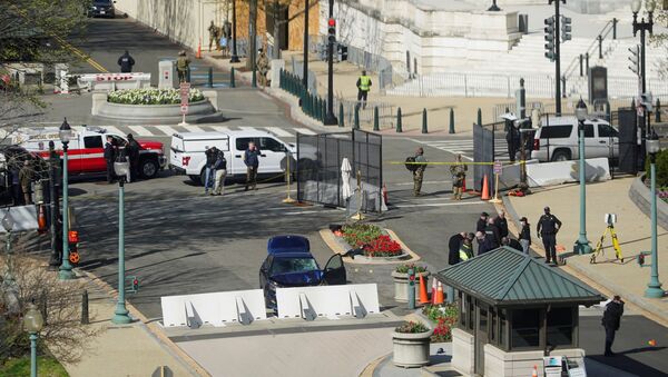A blue car is seen after ramming a police barricade outside the U.S. Capitol building in an incident that reportedly resulted in the death of one Capitol police officer, the injury of another officer and the death of the driver as a result of police gunfire on Capitol Hill in Washington, U.S., April 2, 2021 - Sputnik International