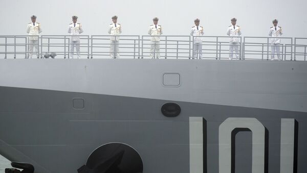 Sailors stand on the deck of the new type 055 guided-missile destroyer Nanchang of the Chinese People's Liberation Army (PLA) Navy as it participates in a naval parade to commemorate the 70th anniversary of the founding of China's PLA Navy in the sea near Qingdao in eastern China's Shandong province, Tuesday, 23 April 2019 - Sputnik International
