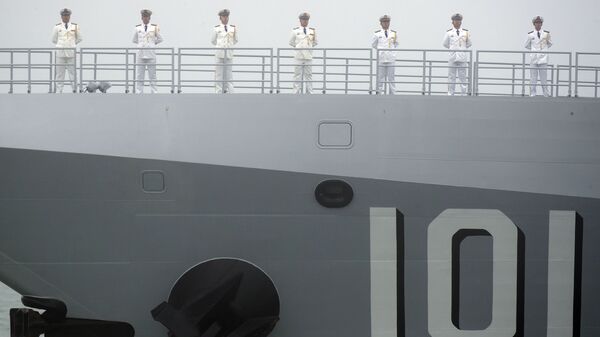 Sailors stand on the deck of the new type 055 guided-missile destroyer Nanchang of the Chinese People's Liberation Army (PLA) Navy as it participates in a naval parade to commemorate the 70th anniversary of the founding of China's PLA Navy in the sea near Qingdao in eastern China's Shandong province, Tuesday, 23 April 2019 - Sputnik International