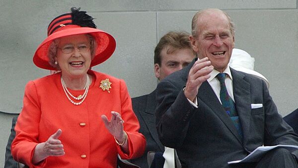 Britain's Queen Elizabeth II laughs with her husband, Prince Philip, as they watch a parade in The Mall in London Tuesday, June 4, 2002, as part of the Golden Jubilee celebrations.  - Sputnik International