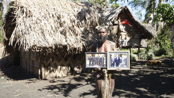 Albi Nagia poses with photographs of Prince Philip in Yakel, Tanna island, Vanuatu. Nagia is part of a movement which worships the prince as the son of their ancestral God.  - Sputnik International