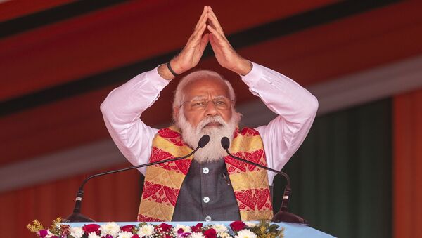 Indian Prime Minister Narendra Modi greets the crowd as he speaks during a public rally in Dhekiajuli, Assam, India, Sunday, Feb. 7, 2021.  - Sputnik International