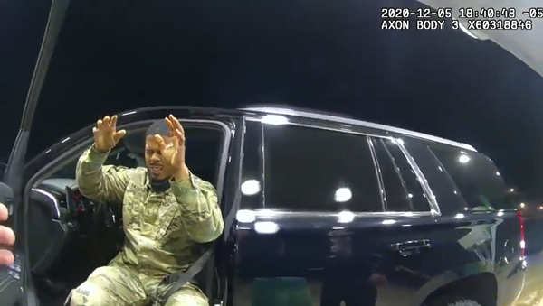 Screenshot from bodycam footage of Virginia police officers showing army officer Caron Nazario squinting after being pepper-sprayed by a cop - Sputnik International