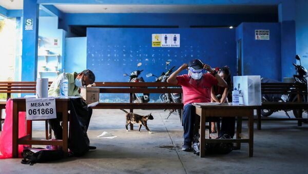 Electoral workers sit at their desks during the presidential and parliamentary elections, at a polling station in Belen, Peru April 11, 2021 - Sputnik International
