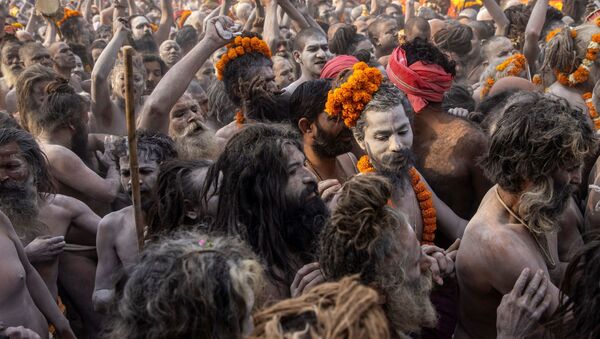 Naga Sadhus, or Hindu holy men participate in the procession for taking a dip in the Ganges river during Shahi Snan at Kumbh Mela, or the Pitcher Festival, amidst the spread of the coronavirus disease (COVID-19), in Haridwar, India, April 12, 2021 - Sputnik International