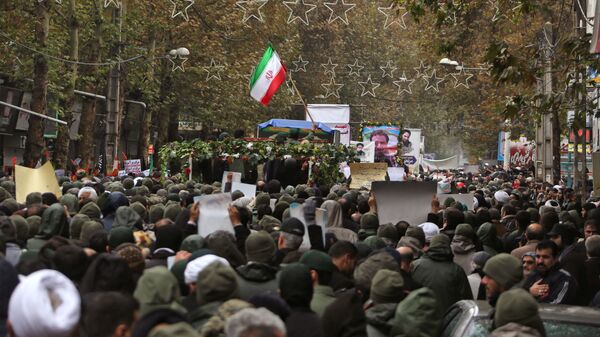 Iranian mourners attend the funeral of Morteza Ebrahimi, a commander of the Islamic Revolutionary Guard Corps, who was killed in violent demonstrations that erupted across Iran last week against a surprise petrol price hike, on November 20, 2019 in the central Iranian city of Shahriar. - Sputnik International