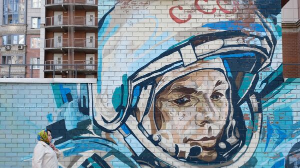 A woman walks past a mural depicting cosmonaut Yuri Gagarin in Krasnogorsk, Moscow region, Russia April 11, 2021. - Sputnik International