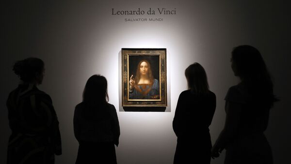 In this Oct. 24, 2017, file photo, people gather around Leonardo da Vinci's Salvator Mundi on display at Christie's auction rooms in London.  - Sputnik International