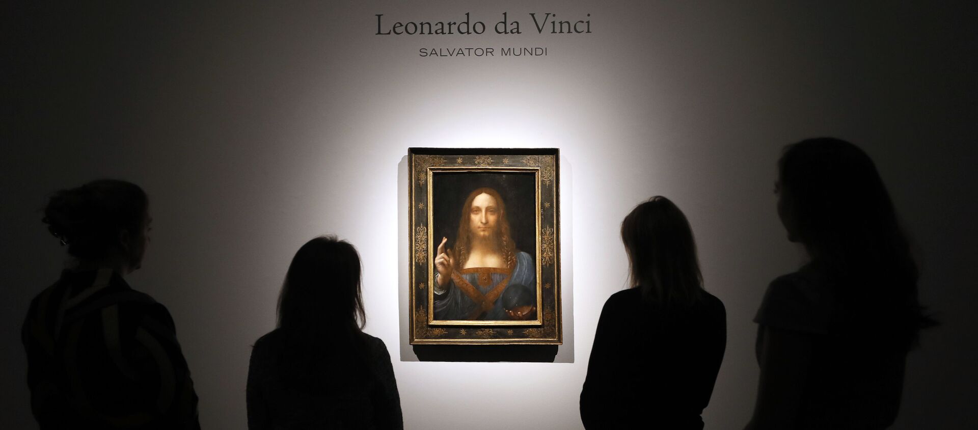 In this Oct. 24, 2017, file photo, people gather around Leonardo da Vinci's Salvator Mundi on display at Christie's auction rooms in London.  - Sputnik International, 1920, 13.04.2021