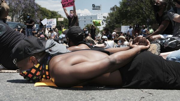 Devion Coleman joins LGBTQ community members and Black Lives Matter protesters as they lay on the street with their hands on their backs in West Hollywood, Calif. on Wednesday, June 3, 2020, over the death of George Floyd, a black man who died in police custody in Minneapolis on Memorial Day - Sputnik International