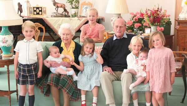 Britain's Queen Elizabeth and Prince Philip sit with Prince George, Prince Louis, Savannah Phillips, Princess Charlotte, Isla Phillips, Lena Tindall, and Mia Tindall in this undated picture released on April 14, 2021. - Sputnik International