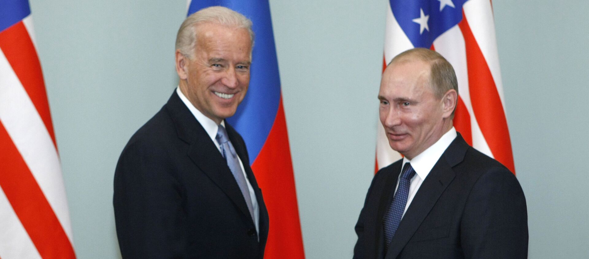 In this March 10, 2011, file photo, Vice President of the United States Joe Biden, left, shakes hands with Russian Prime Minister Vladimir Putin in Moscow, Russia. - Sputnik International, 1920, 25.05.2021