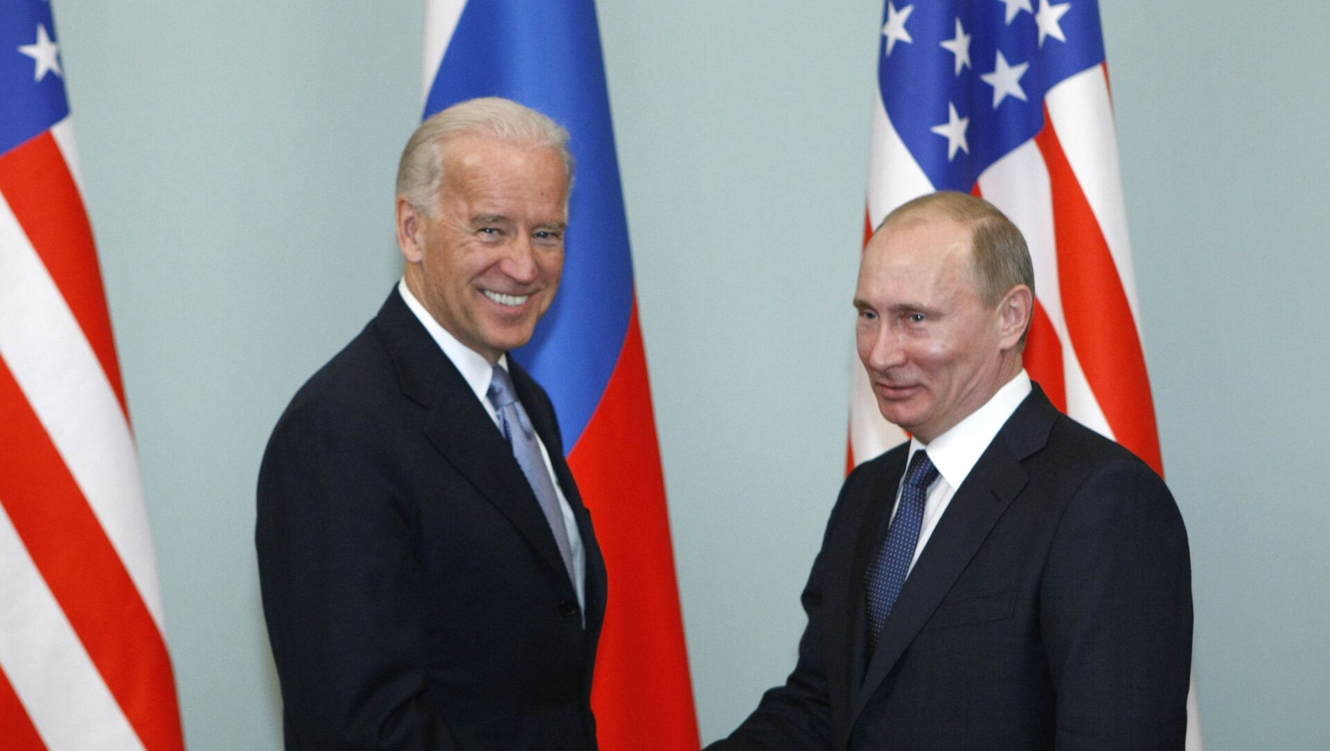 In this March 10, 2011, file photo, Vice President of the United States Joe Biden, left, shakes hands with Russian Prime Minister Vladimir Putin in Moscow, Russia. - Sputnik International, 1920, 04.06.2021