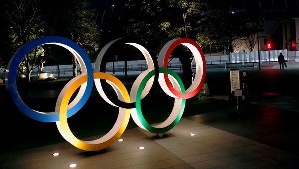 The Olympic rings are illuminated in front of the National Stadium in Tokyo, Japan January 22, 2021. - Sputnik International