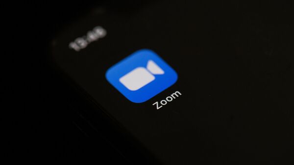 This illustration picture taken on May 27, 2020 in Paris shows the logo of the social network  application Zoom on the screen of a phone - Sputnik International