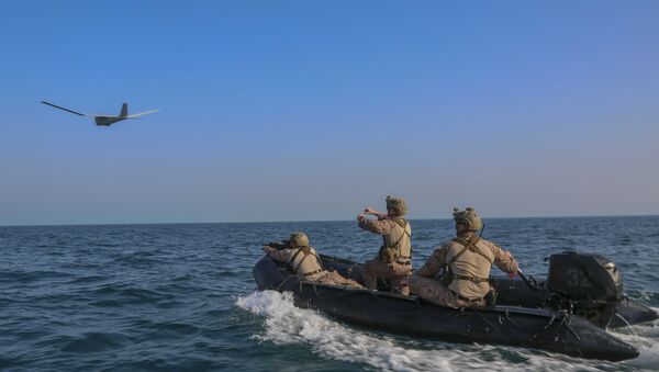 A reconnaissance Marine launches an RQ-20 Puma aboard a combat rubber raiding craft, May 24, 2020 - Sputnik International