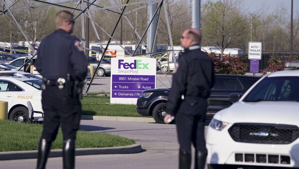 Police stand near the scene where multiple people were shot at the FedEx Ground facility early Friday morning, April 16, 2021, in Indianapolis. A gunman killed eight people and wounded several others before apparently taking his own life in a late-night attack at a FedEx facility near the Indianapolis airport, police said, in the latest in a spate of mass shootings in the United States after a relative lull during the pandemic - Sputnik International
