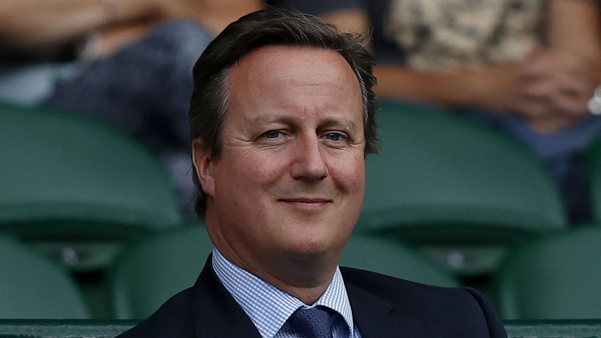 Britain's former Prime Minister David Cameron sits in the Royal Box on Centre Court following the women's singles semi-finals on the tenth day of the 2017 Wimbledon Championships at The All England Lawn Tennis Club in Wimbledon, southwest London, on July 13, 2017 - Sputnik International, 1920, 13.11.2023