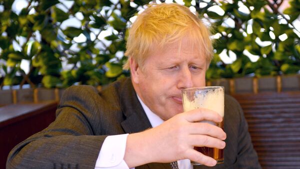 Prime Minister Boris Johnson sips a pint in the beer garden during a visit to The Mount Tavern Pub and Restaurant on the local election campaign trail in Wolverhampton, West Midlands, Britain April 19, 2021 - Sputnik International